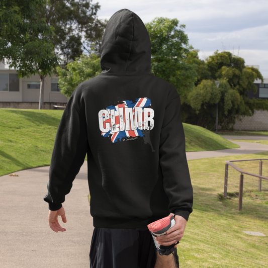 Man wearing UK Climb Community Hoodie with Union Jack and climber design in outdoor setting, emphasizing climbing passion and style.